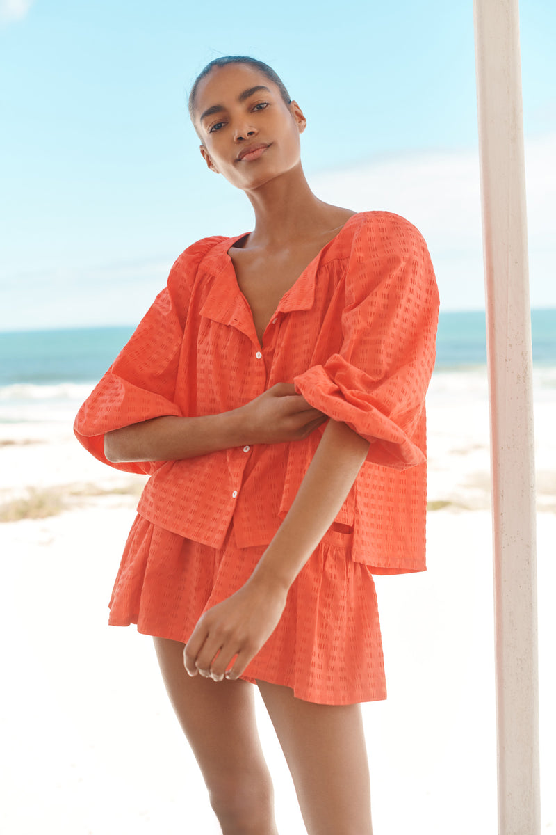 Wiggy Kit | The Pocket Short | Model wearing orange shorts with matching shirt