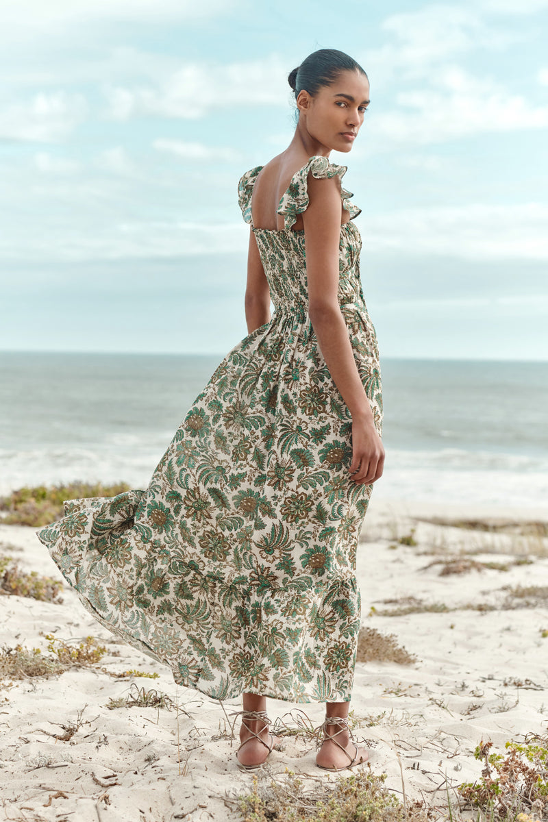 Wiggy Kit | The Carmen Dress | Model wearing maxi jungle print dress, with beach in background