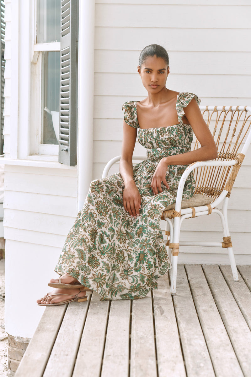 Wiggy Kit | The Carmen Dress | Model wearing maxi jungle print dress, with beach in background