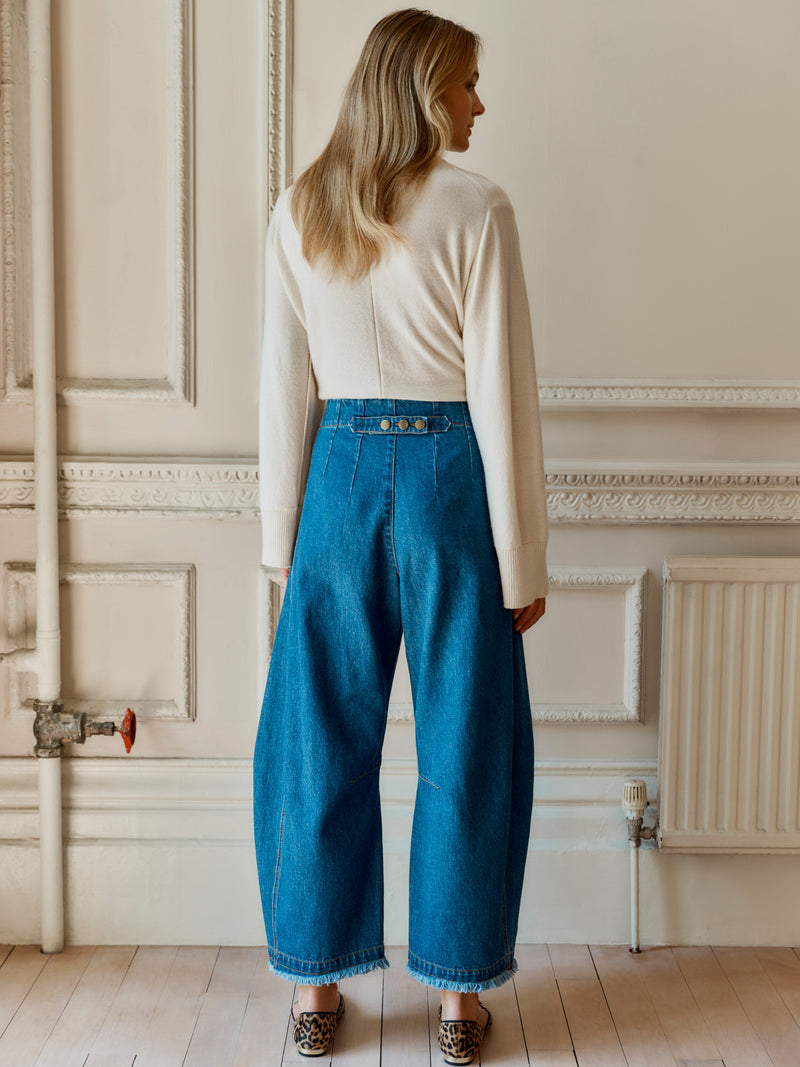 A model wearing the Wiggy Kit Rancher Jean facing away showing the button detail on the waistline.