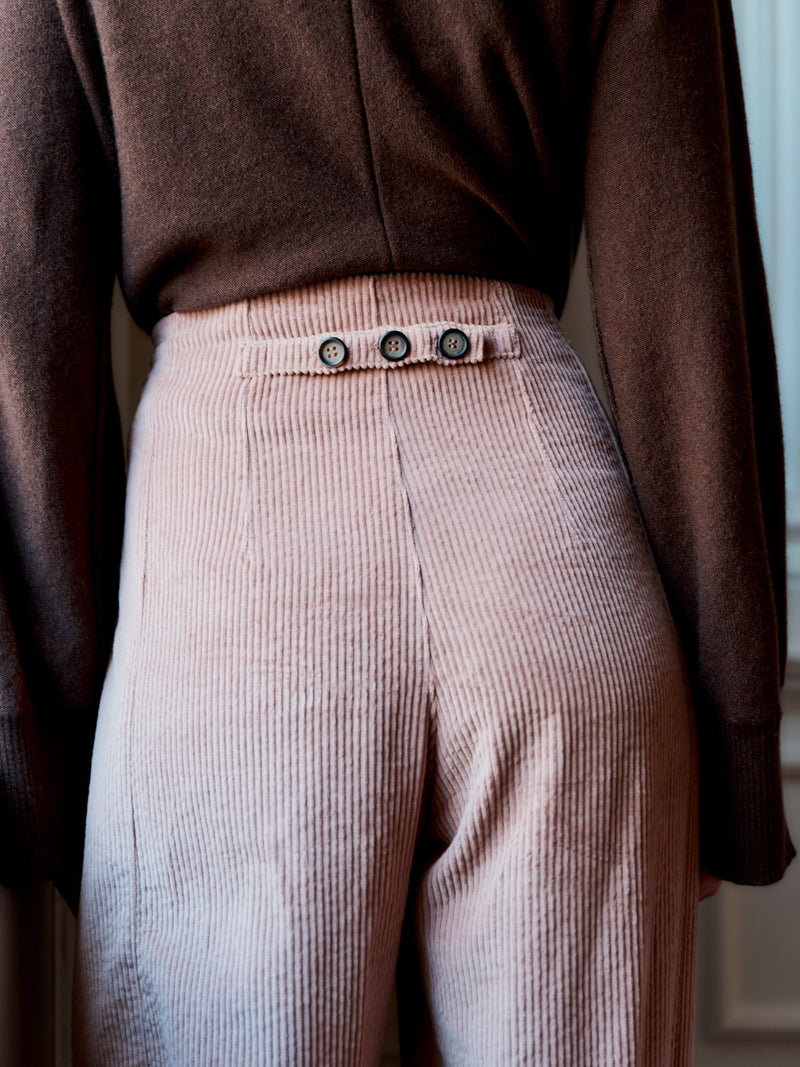 Wiggy Kit model wearing The Rancher Cord facing away to show the button detail on the rear waistline.