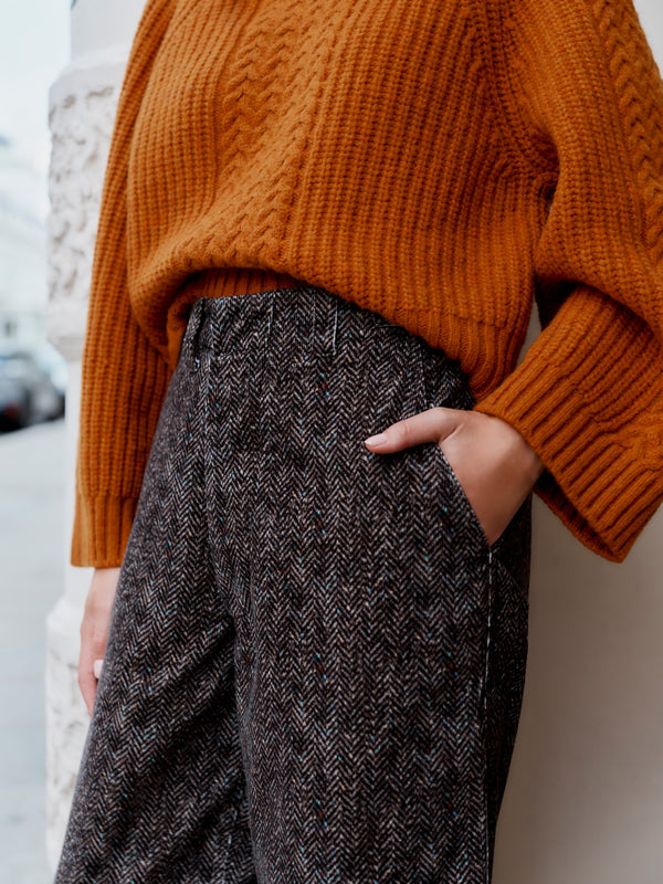 A model wearing the Wiggy Kit Cord Chore Pants and Orange Slouch Fisherman's Crew jumper.