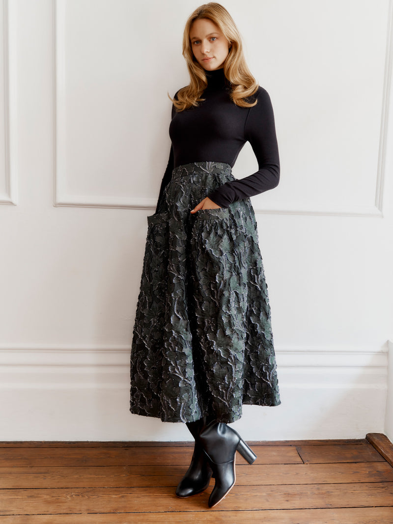 Wiggy Kit model wearing the Gaucho Skirt (Clipped Jacquard) and High Neck Body top.