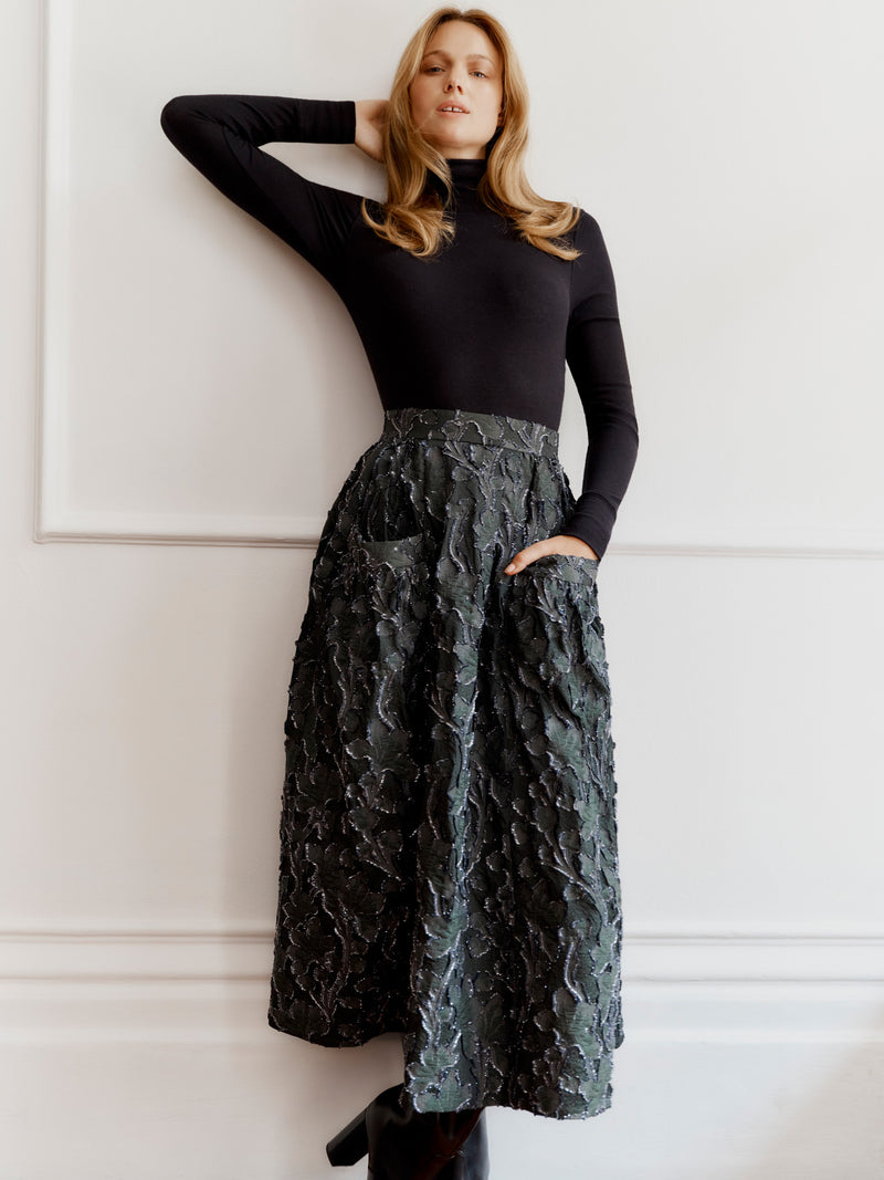 Wiggy Kit model wearing The Goucho Skirt (clipped jacquard) and the black High Neck body top.