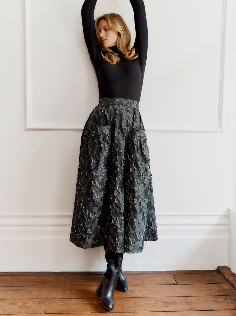 Wiggy Kit model wearing the Gaucho Skirt (Clipped Jacquard) and High Neck Body top.