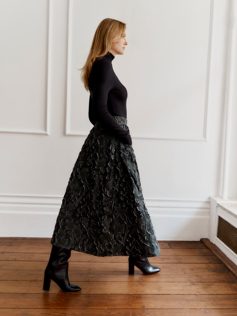 Wiggy Kit model wearing the Gaucho Skirt (Clipped Jacquard) and High Neck Body top walking to the right.