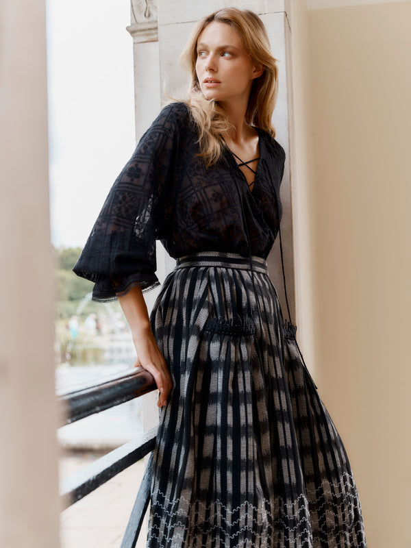 Wiggy Kit model wearing the Embroidered Gaucho Skirt and Pirate Shirt leaning on balcony railing.