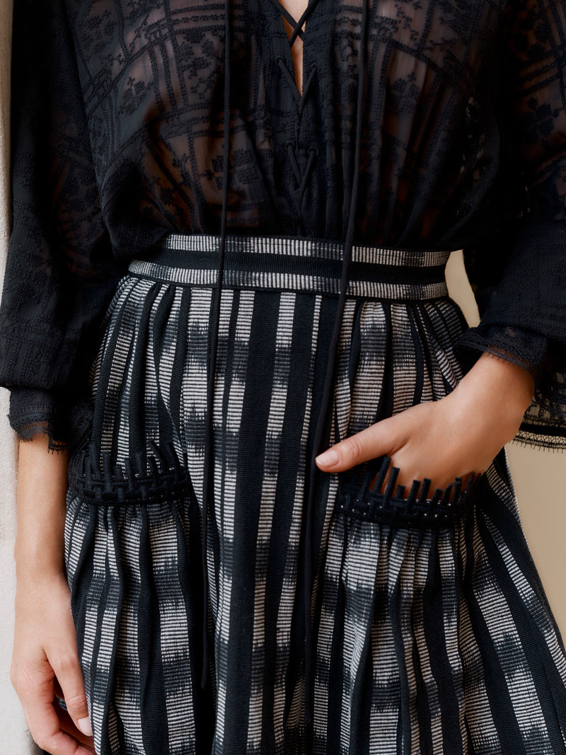 Wiggy Kit model wearing the Embroidered Gaucho Skirt with hand in pocket.