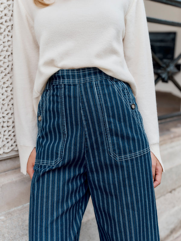 A close up detail of Wiggy Kit's The Jean trouser on a model leaning on a wall.