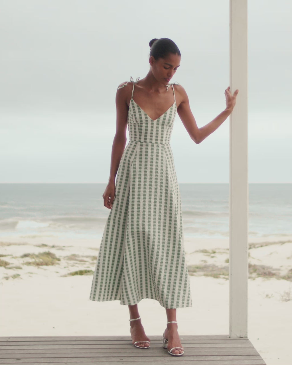 Wiggy Kit | Ekberg Dress (Green Gingham) | Model wearing maxi gingham dress with beach in background